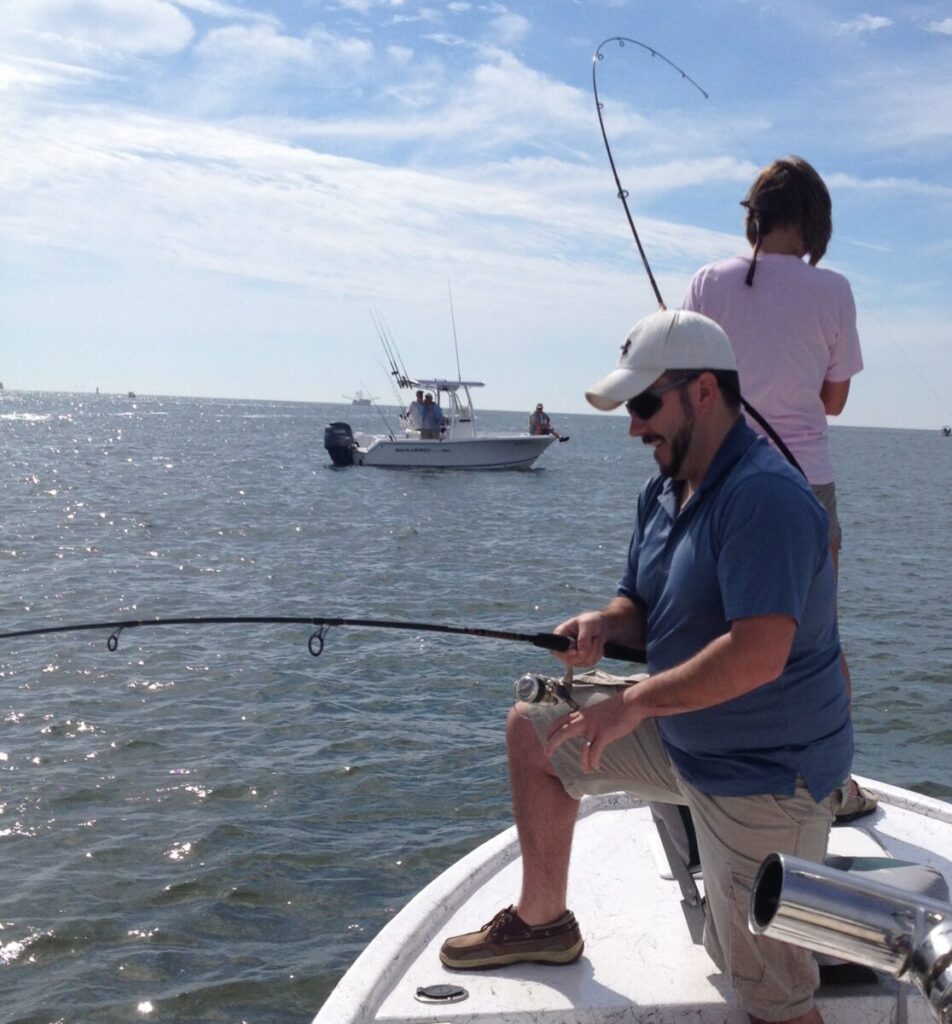 two people fighting redfish on a inshore fishing charter in myrtle beach