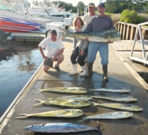men and woman standing on the dock with mahi mahi and wahoo laid out on the dock. Gulf Stream Fishing Myrtle Beach with North Myrtle Beach Fishing Charters