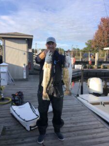 Top Myrtle Beach Inshore Fishing Guide Captain Keith Logan Holding Speckled Sea Trout on the dock.