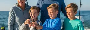 Family fishing together on a boat in Myrtle Beach, showcasing joy and bonding during their fishing adventure