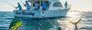 Deep-sea fishing charter boat with anglers fishing in clear blue ocean waters