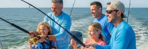 Family fishing on a charter boat in Myrtle Beach, showcasing a sunny day and joyful experiences